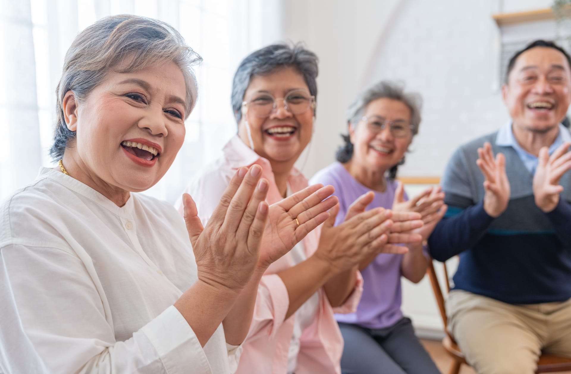 Caregiver support group clapping, having a good time.